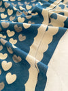 Close-up of blue fabric with beige heart patterns
