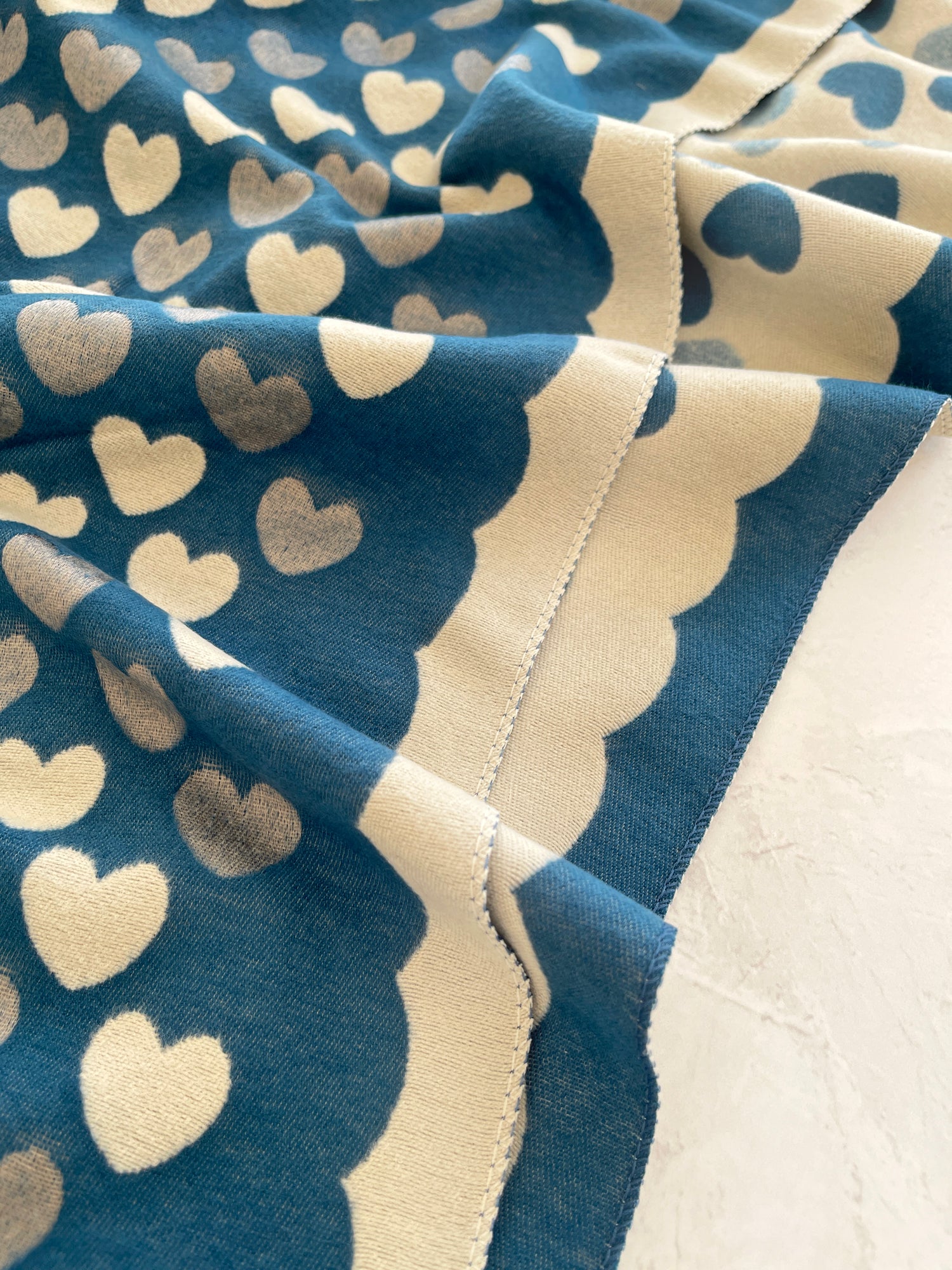 Close-up of blue fabric with beige heart patterns